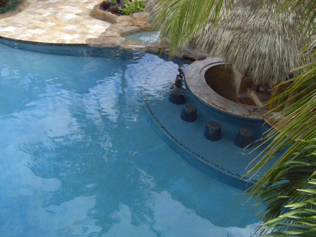 Faux rock pool bar in the pool by Sammet Pools - South Florida Pool Designer and Builder